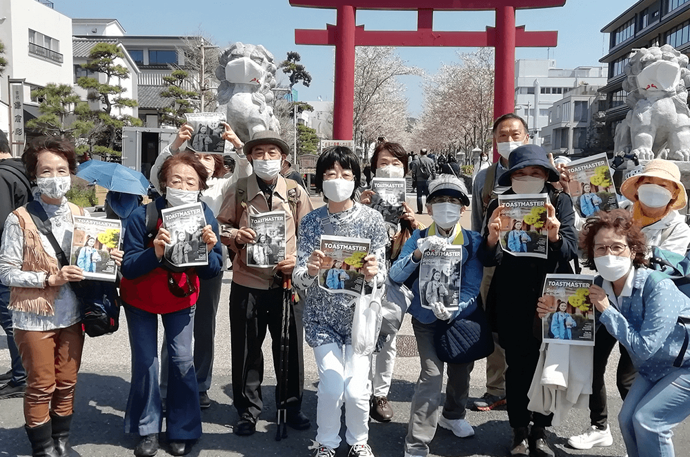 Group of people standing in front of Japanese landmark