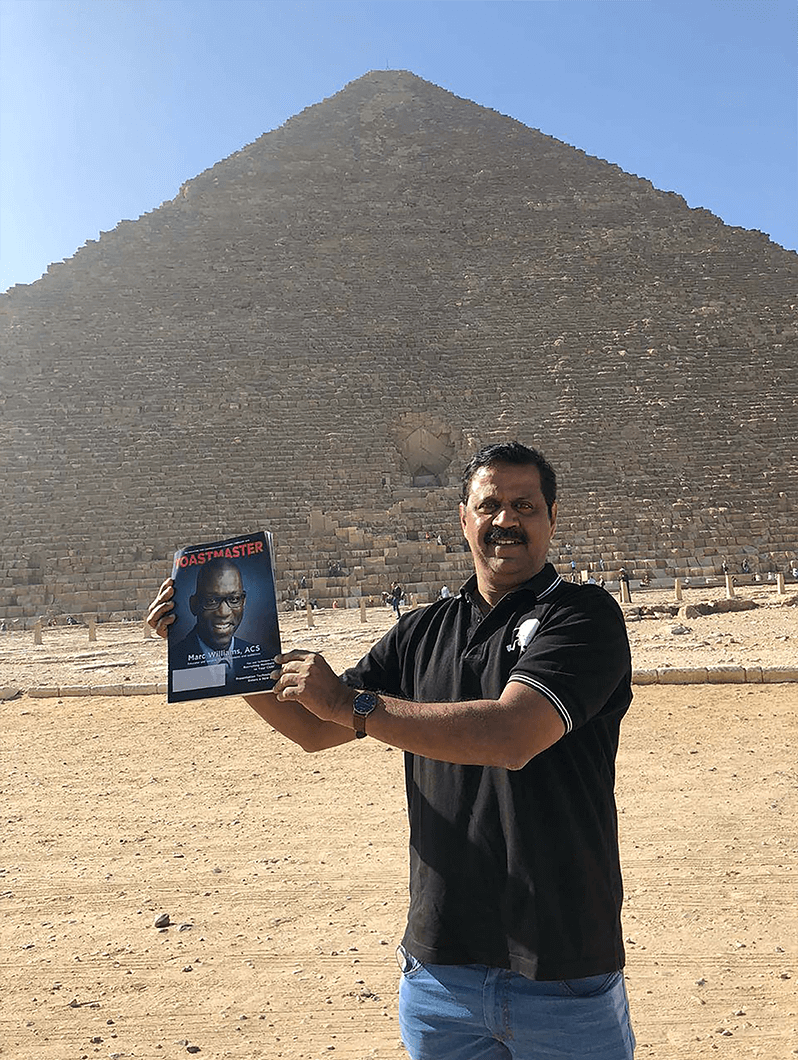 Kathiravan M. Pethi, DTM, of Bangalore, India, smiles in front of the Great Pyramid of Giza.