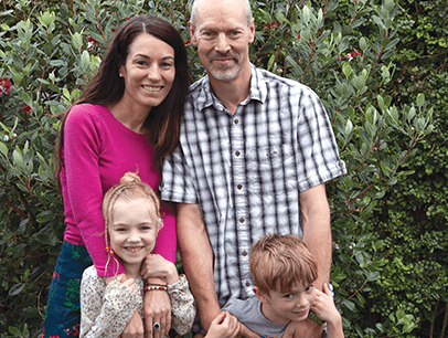 Priscilla Dickinson, husband, young daughter, young son posing outside