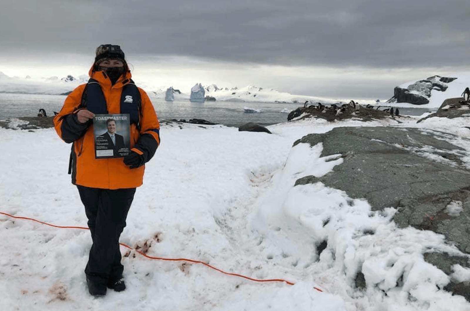 Lisa Kaul of Santa Clarita, California, shares a frozen beach with penguins on the peninsula of Antarctica.