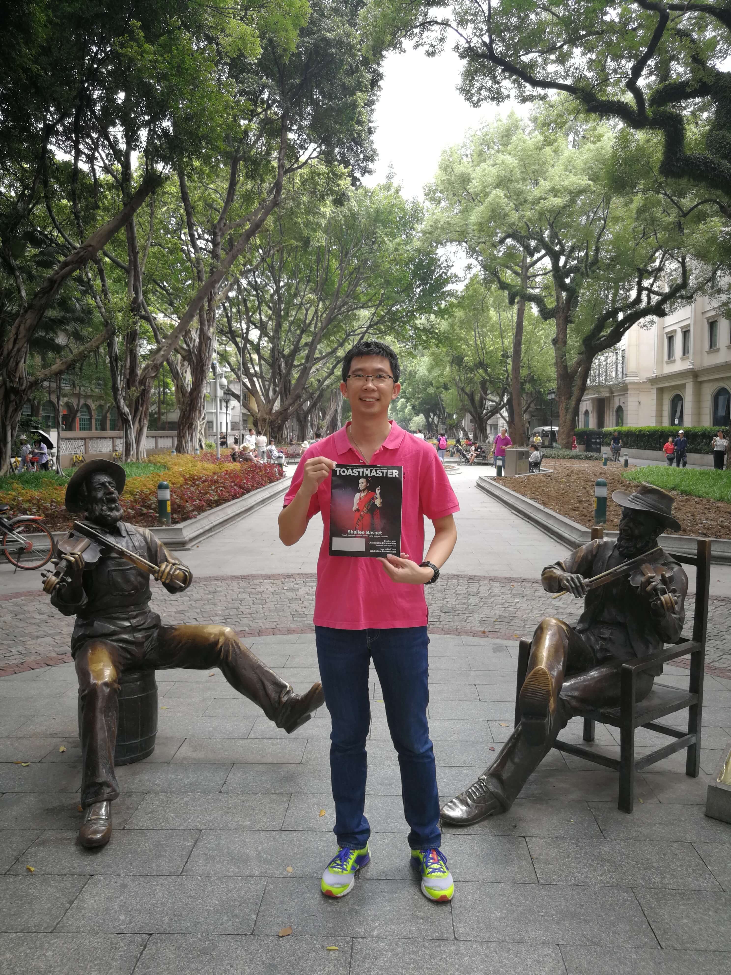 Goh Chee Yong of Petaling Jaya, Malaysia, stands between two violinist statues in Shamian Park, a sandbank island in Guangzhou, China.