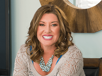 Kelly Russell sitting on chair and smiling