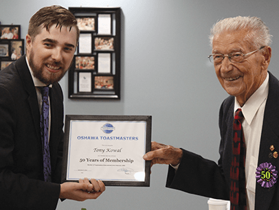 Mitchell Kent presents Tony Kowal with certificate