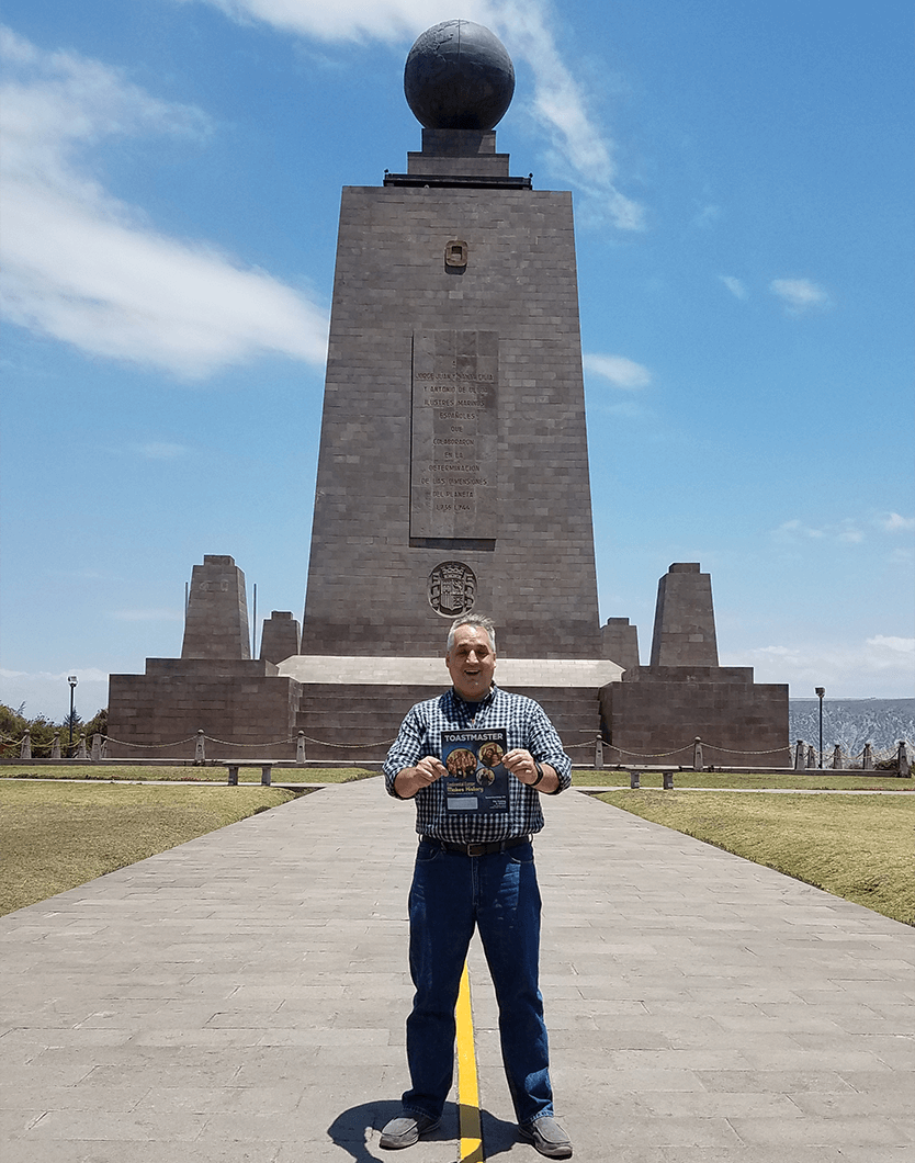 Bob Holzwarth of Rochester, New York, stands in front of the Monument to the Equator in Quito Ecuador. The yellow line marks the line of the equator, so Bob is standing in two hemispheres at once.