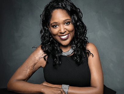 Andrea Pitts in black sleeveless shirt and smiling
