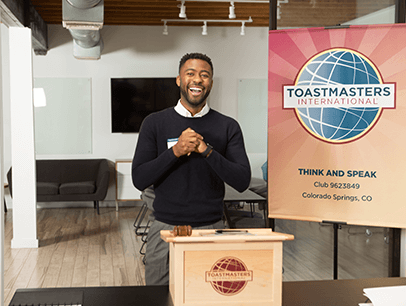 man laughing at podium