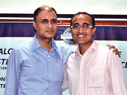 Man in blue shirt posing with mentor