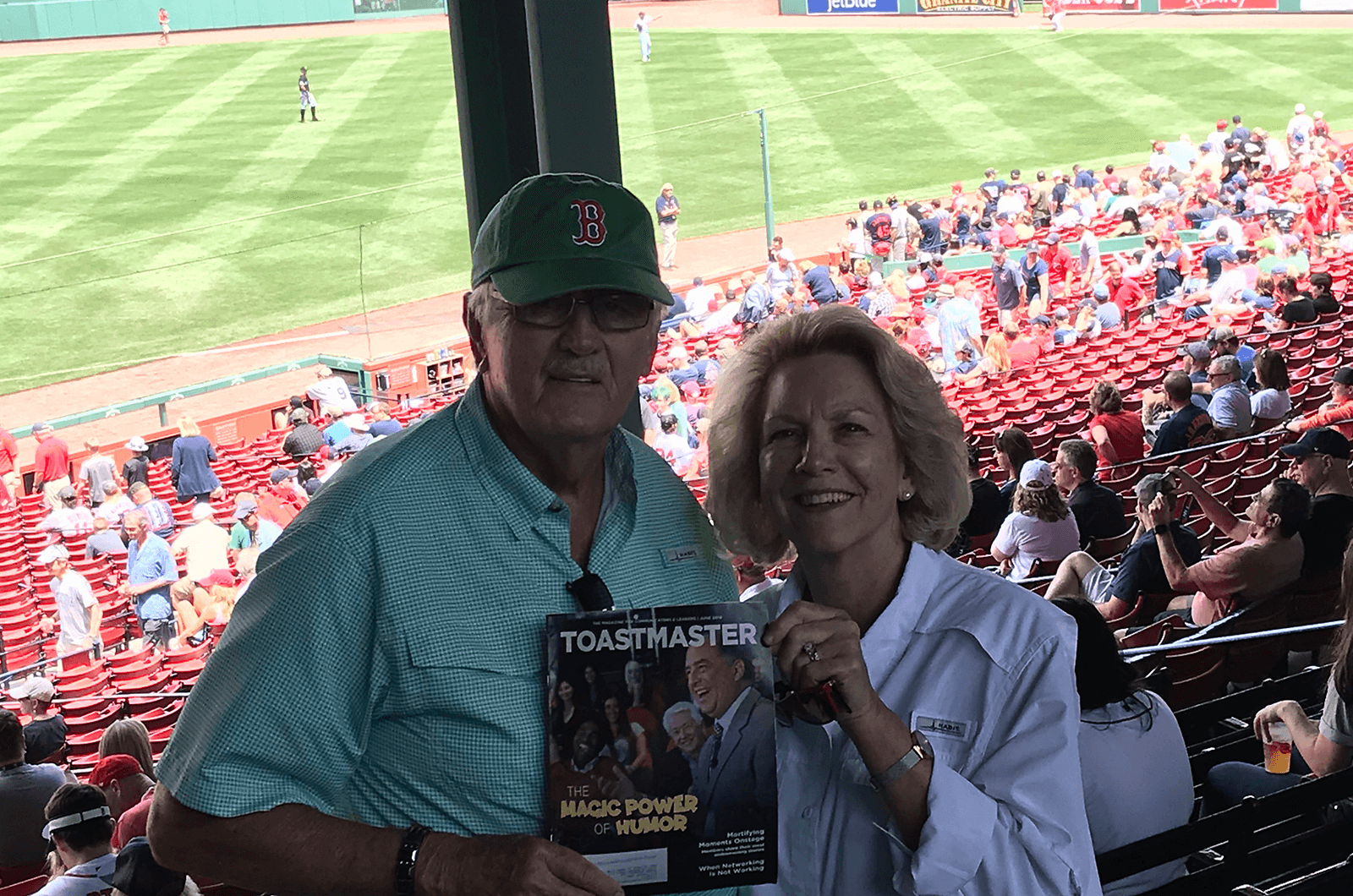Distinguished Toastmasters Barbara and George Strasdas of Port St. Lucie, Florida, attend a Boston Red Sox baseball game in Boston, Massachusetts. Fenway Park has been home to the professional baseball team since 1912, making it the oldest ballpark in Major League Baseball.