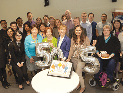 Group of Toastmasters members with silver balloons spelling out 505