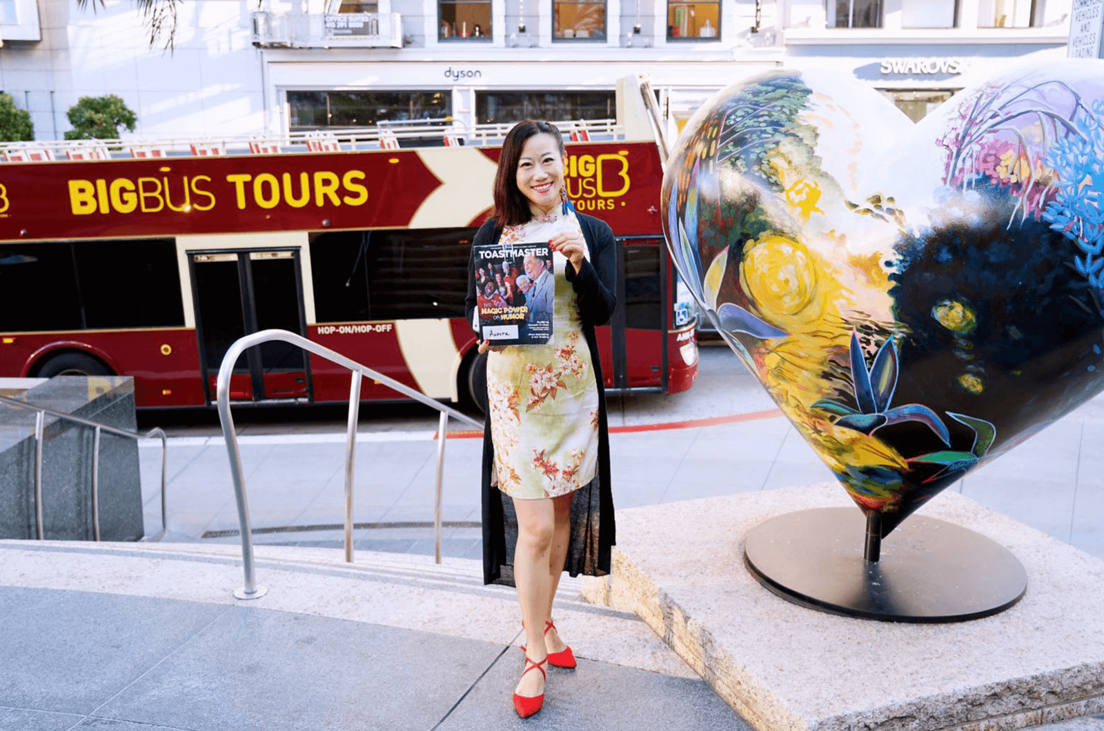 Aurora Zheng of Qingdao, Shandong, China, takes a photo alongside a heart sculpture in San Francisco’s Union Square in California.