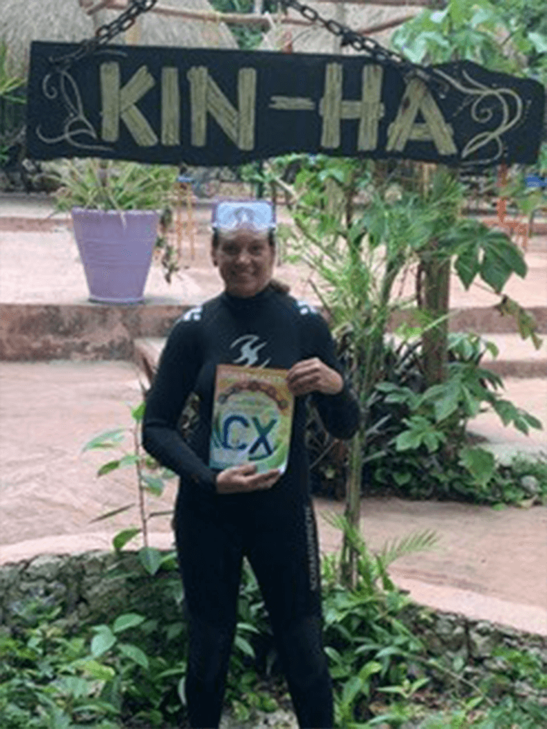 Sue Ann Kern, DTM, of Park City, Utah, prepares for a scuba dive in in the underground caverns of the Kin-Ha Cenotes in Puerto Morelos, Mexico.