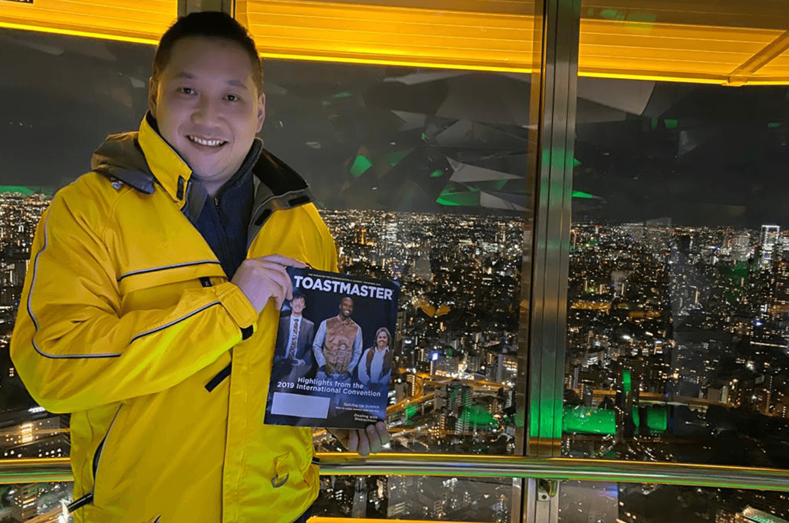 Matthew Lee, DTM, of Kwun Tong, Hong Kong, stands in the Tokyo Tower—the second-tallest structure in Japan.