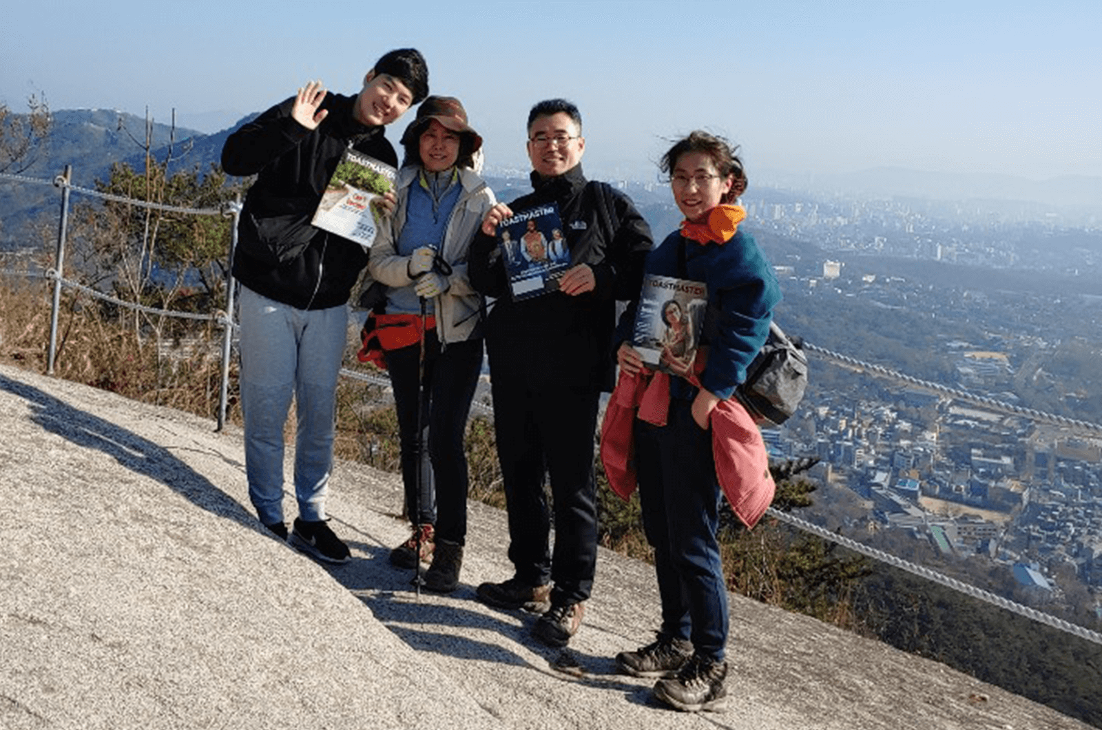 Members of Pacific Sunset Toastmasters of Seoul, Korea, hike Inwangsan Mountain near Seoul City. The mountain’s name means “mountain of generous king” in Korean.