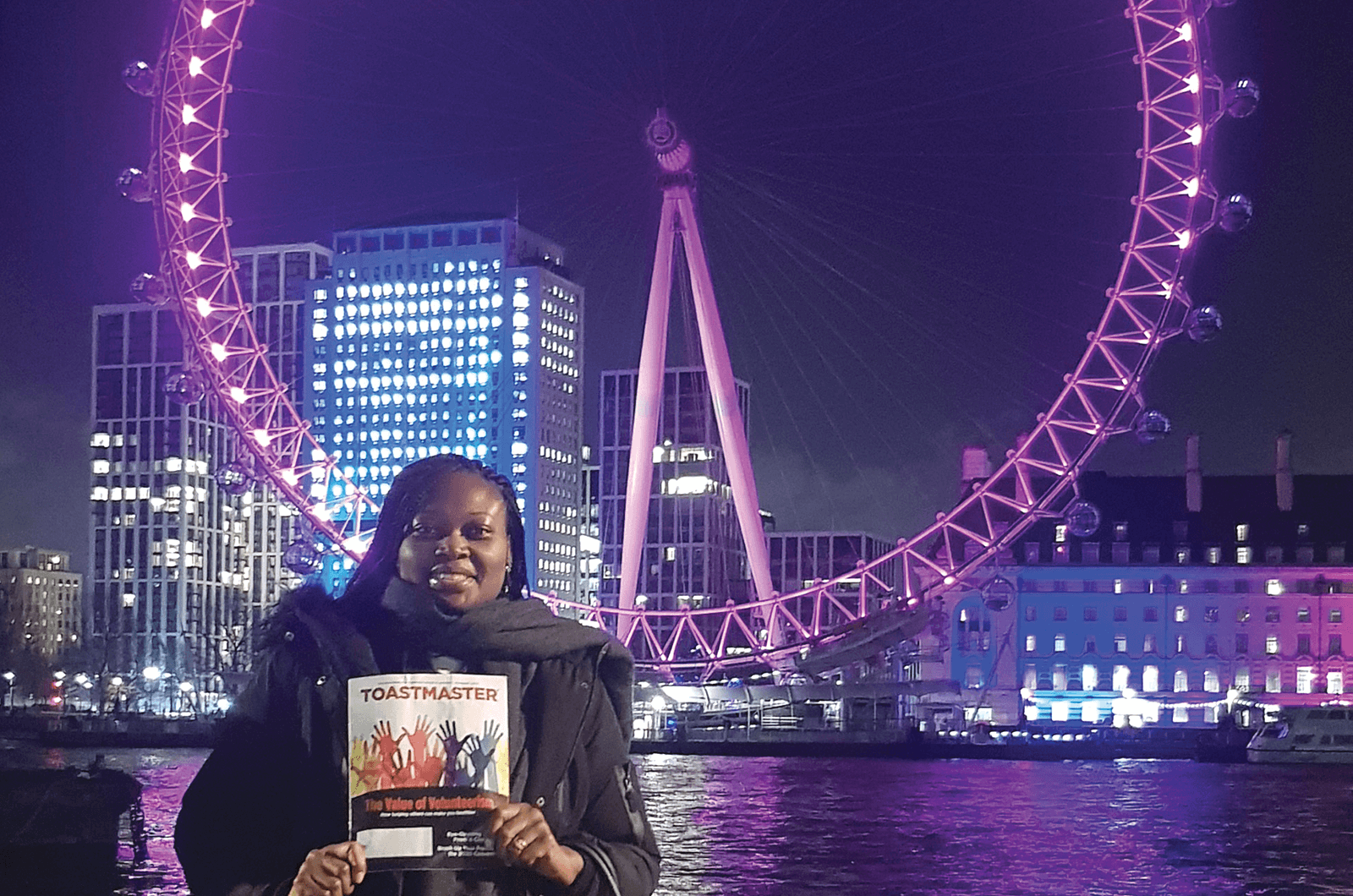 Patricia Dzifa Mensah-Larkai, DTM, of London, England, poses in front of the London Eye, Europe’s tallest cantilevered observation wheel, to celebrate her 10th Toastmasters anniversary.