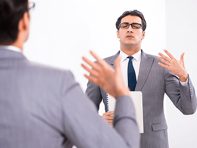 Man looking in mirror warming up for speech