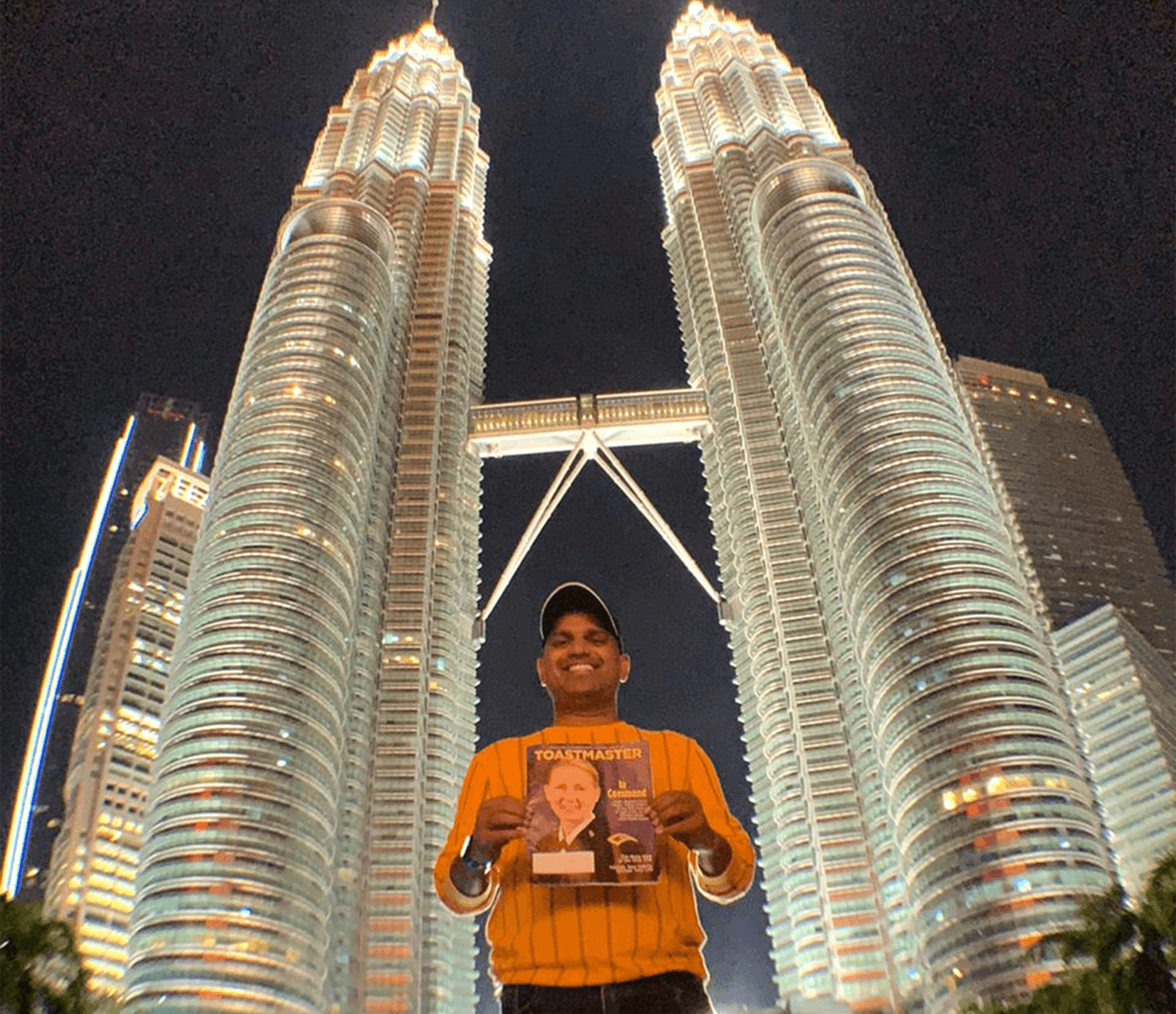 Ramakanth Konatham, DTM, of Hyderabad, Telangana, India, poses between the Petronas Towers in Kuala Lumpur, Malaysia.