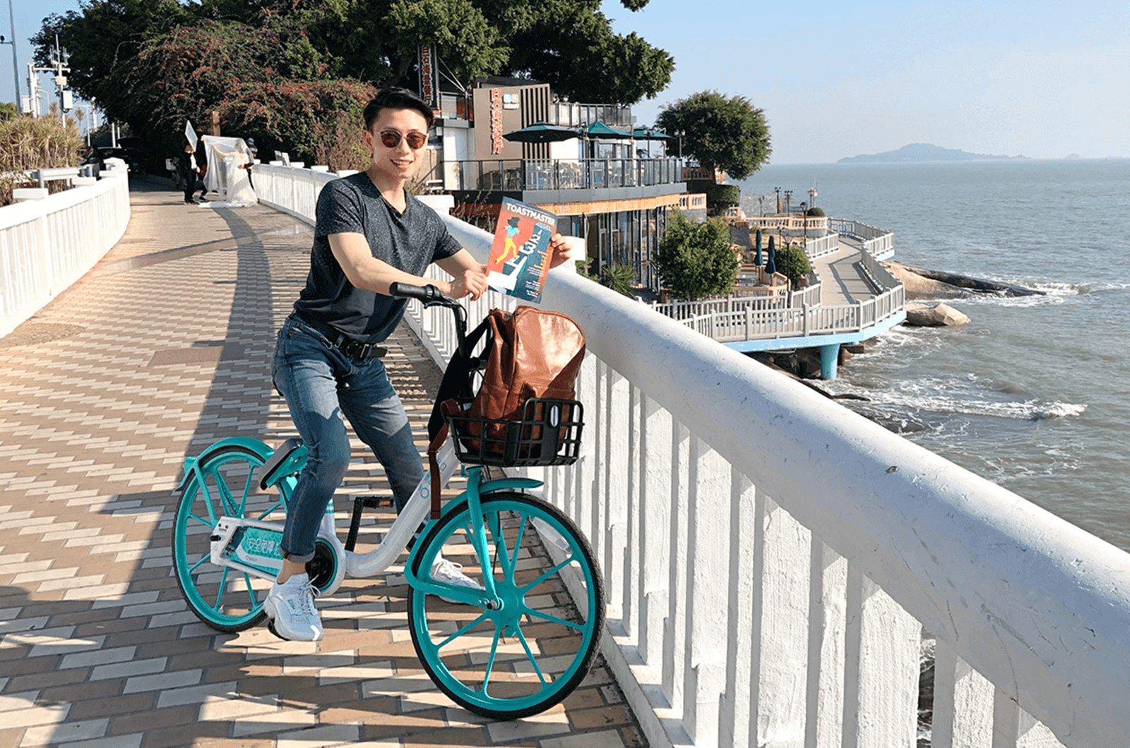 Wes Lu of Edmonton, Alberta, Canada, bikes along the island cycling path of Xiamen, China.