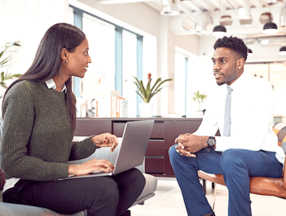 Man and woman sitting down talking during job interview