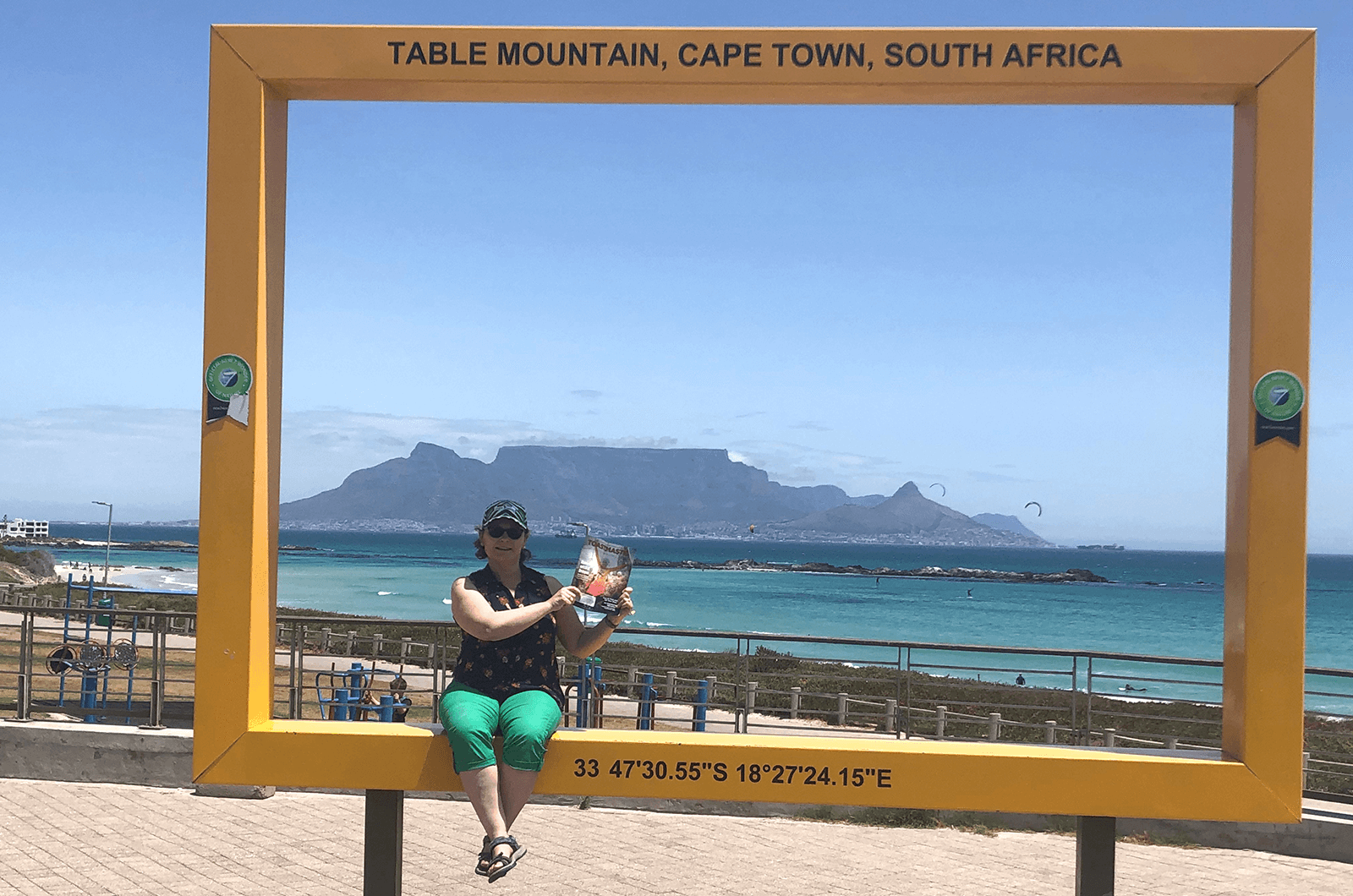 Lucia Lara of Poulsbo, Washington, U.S., sits in a frame with Table Mountain in the background in Cape Town, South Africa.