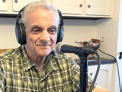 Man wearing headphones with microphone on table