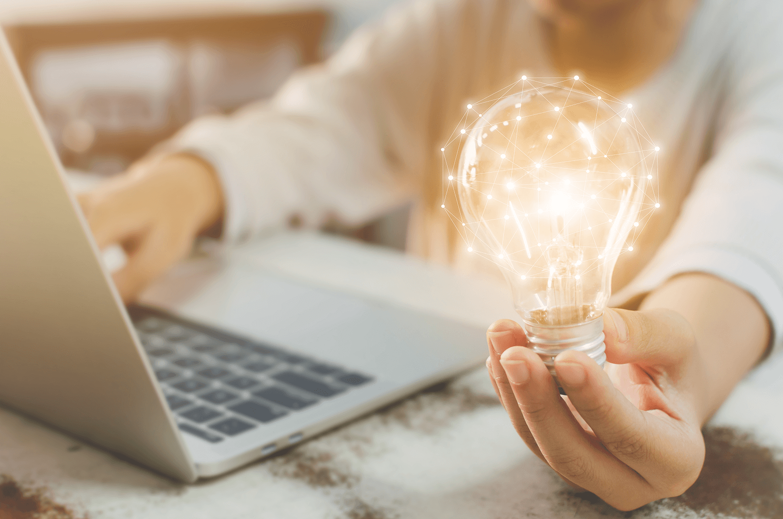 Image of person holding lightbulb lit up