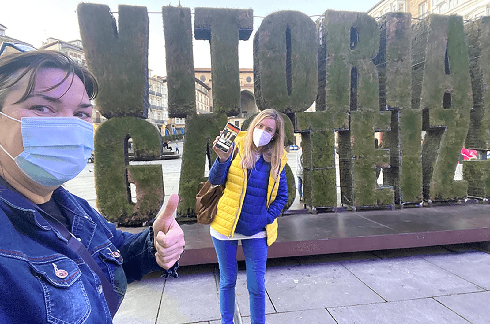 Cristina Juesas, DTM, (pictured left) and Marta Kernstock of Vitoria-Gasteiz, Basque Country, Spain, stop to show the online edition on Marta’s phone as they walk the city while socially distancing.