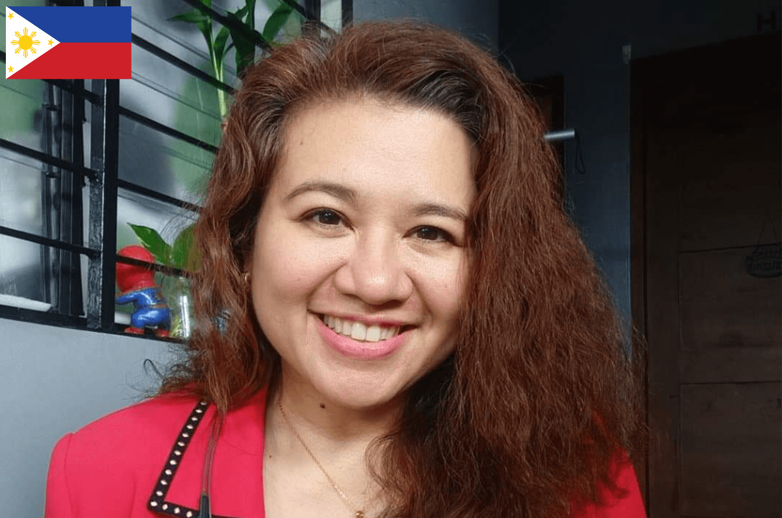 Woman in red jacket smiling