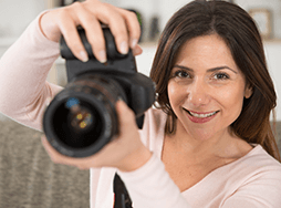Woman holding up camera to take photo