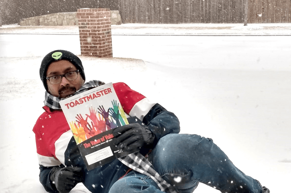Balakrishnan Subramanium of Frisco, Texas, poses in his front yard after a historic Texas winter storm in February 2021.