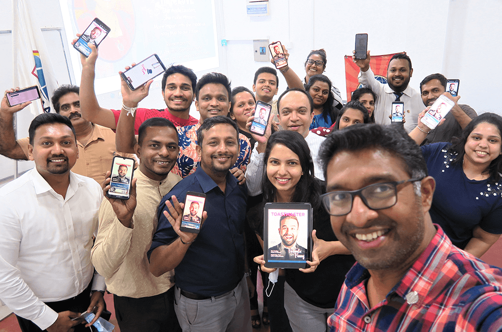 Sri Lanka Institute of Marketing Toastmasters Club members in Colombo, Sri Lanka, pose with the digital edition of the Toastmaster at their club meeting.