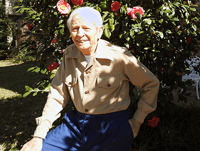 Man wearing tan shirt and smiling