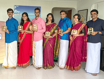 Seven people posing next to banner