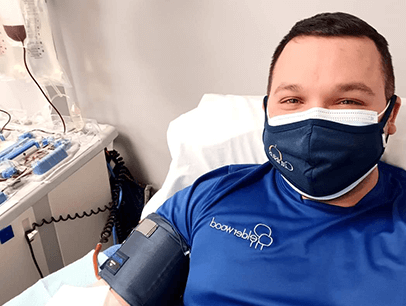 Man wearing mask while donating blood