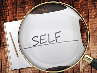 Magnifying glass hovering over word self