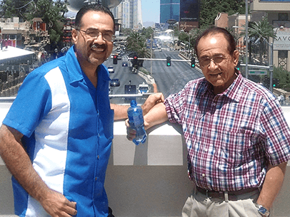 Two men smiling outside