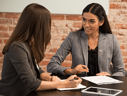 Two women talking at table